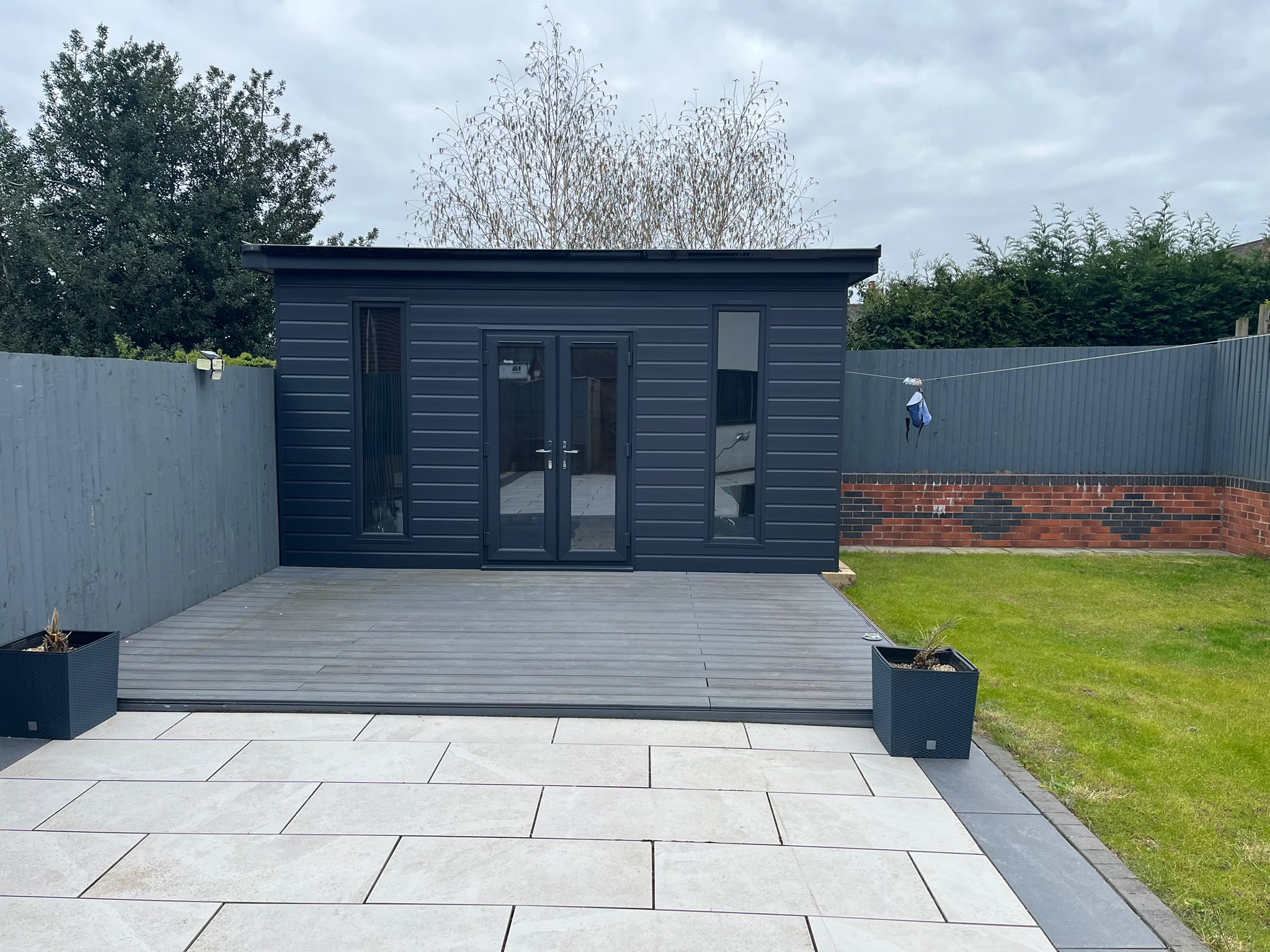 Landscaped garden with patio, decking and garden room